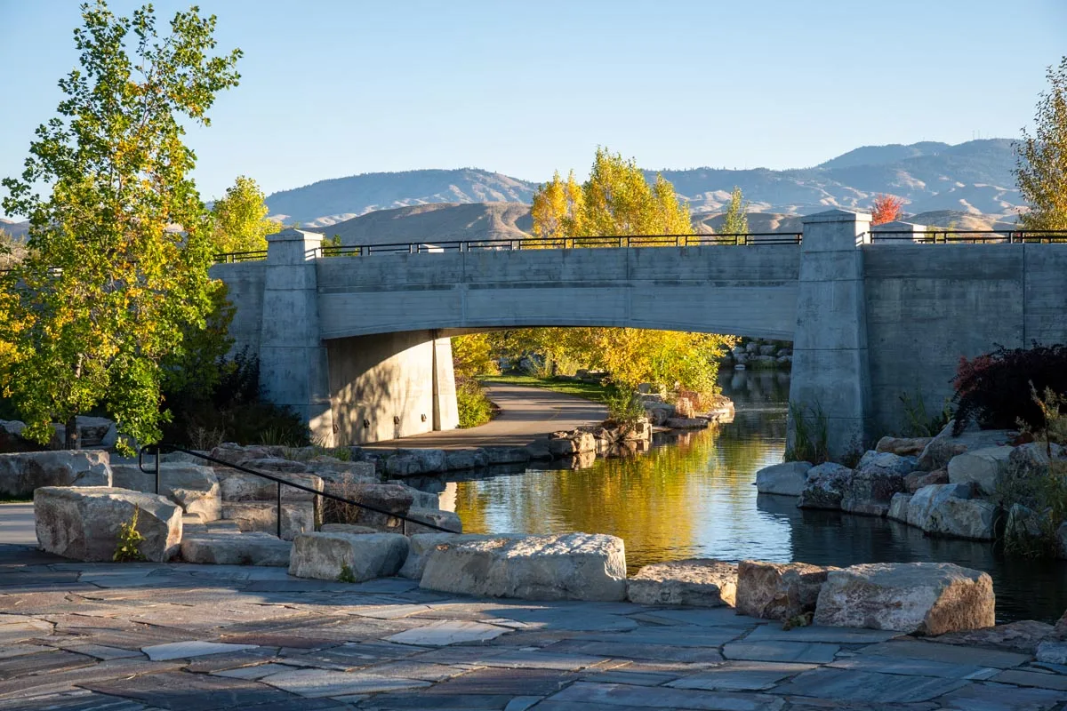 A pedestrian path beside a landscaped waterway in Boise