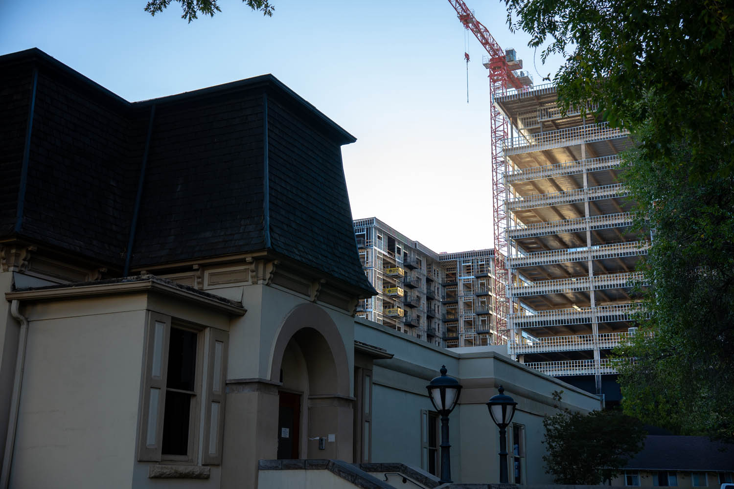 A historic building beside a construction crane in downtown Boise