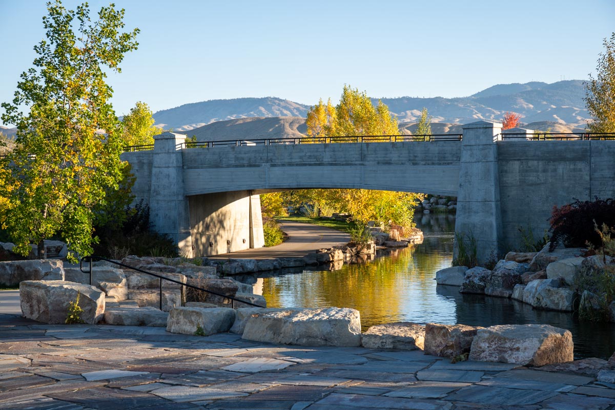 A pedestrian path beside a landscaped waterway in Boise