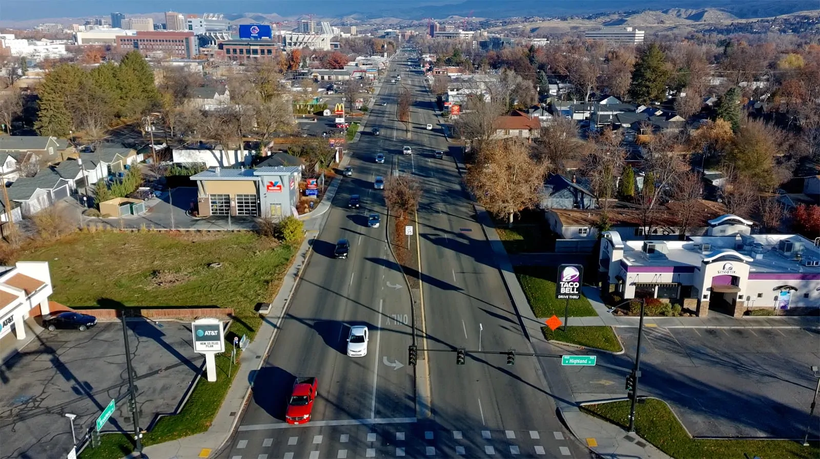 Existing Broadway Avenue at Highland Street with wide travel lanes, commercial frontage, and minimal pedestrian space.